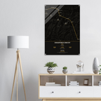 Annapurna Circuit trek route map in the dark colourway, shown as an acrylic glass print mounted on a wall. Jhilke Studio.