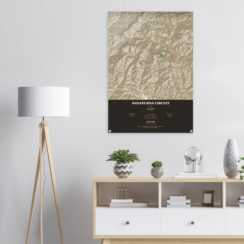 Annapurna Circuit trek route map in the light colourway, shown as an acrylic glass print mounted on a wall. Jhilke Studio.