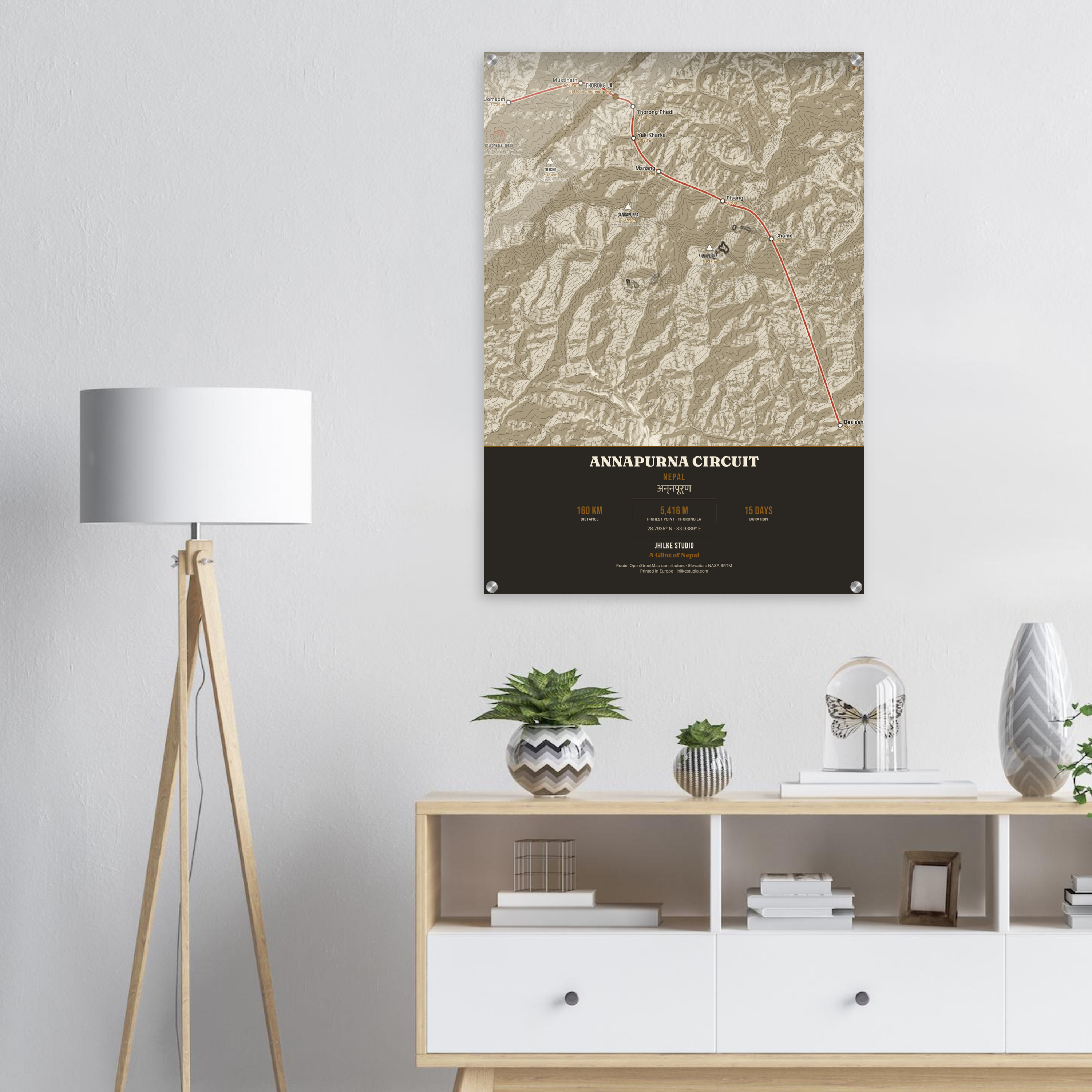 Annapurna Circuit trek route map in the light colourway, shown as an acrylic glass print mounted on a wall. Jhilke Studio.
