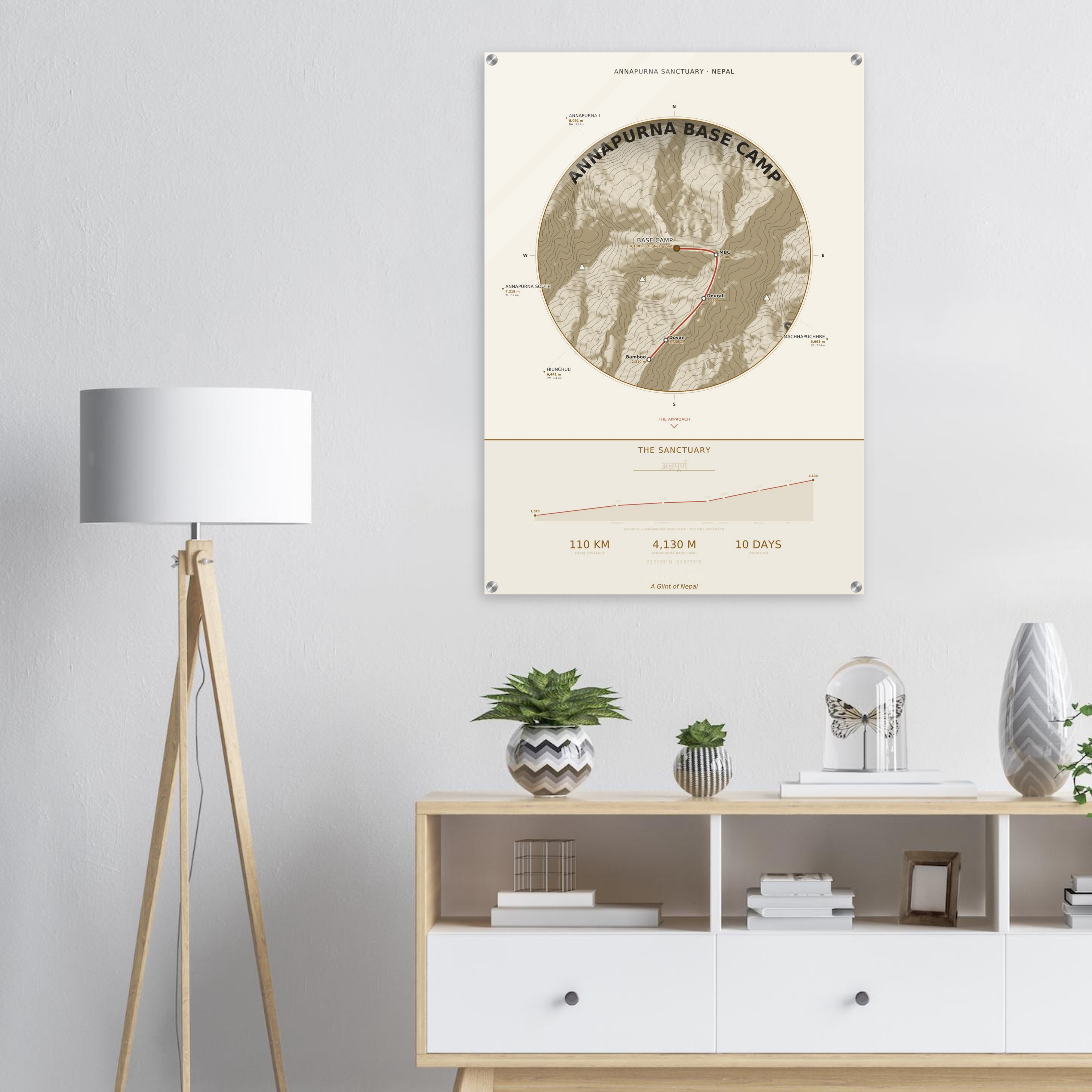 Annapurna Base Camp trek route map in the light colourway, shown as an acrylic glass print mounted on a wall. Jhilke Studio.
