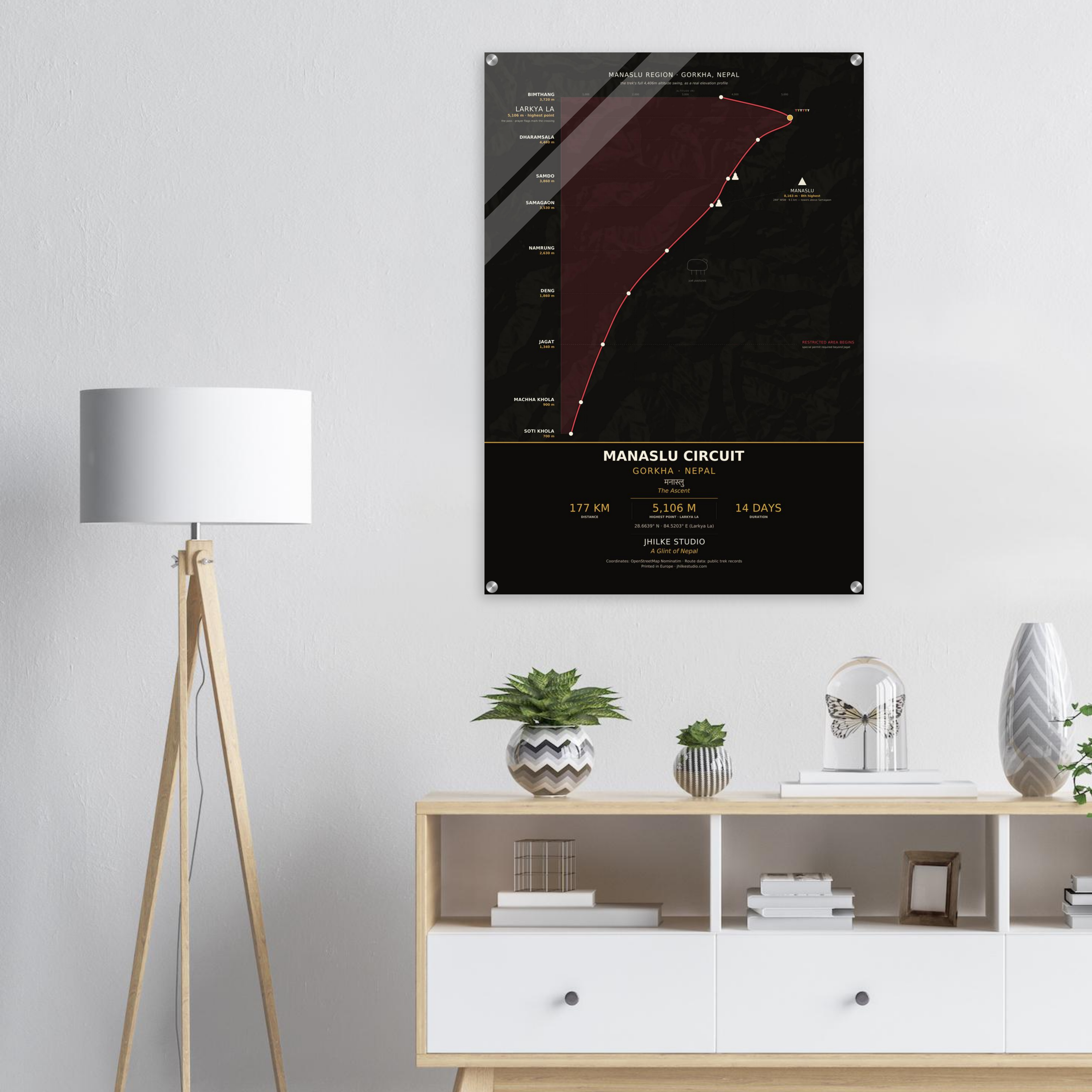 Manaslu Circuit trek route map in the dark colourway, shown as an acrylic glass print mounted on a wall. Jhilke Studio.
