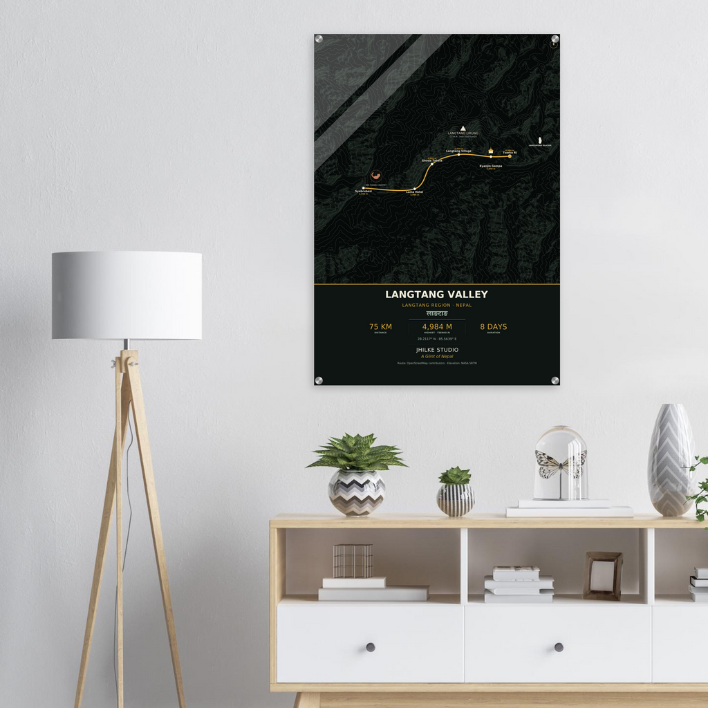 Langtang Valley trek route map in the dark colourway, shown as an acrylic glass print mounted on a wall. Jhilke Studio.