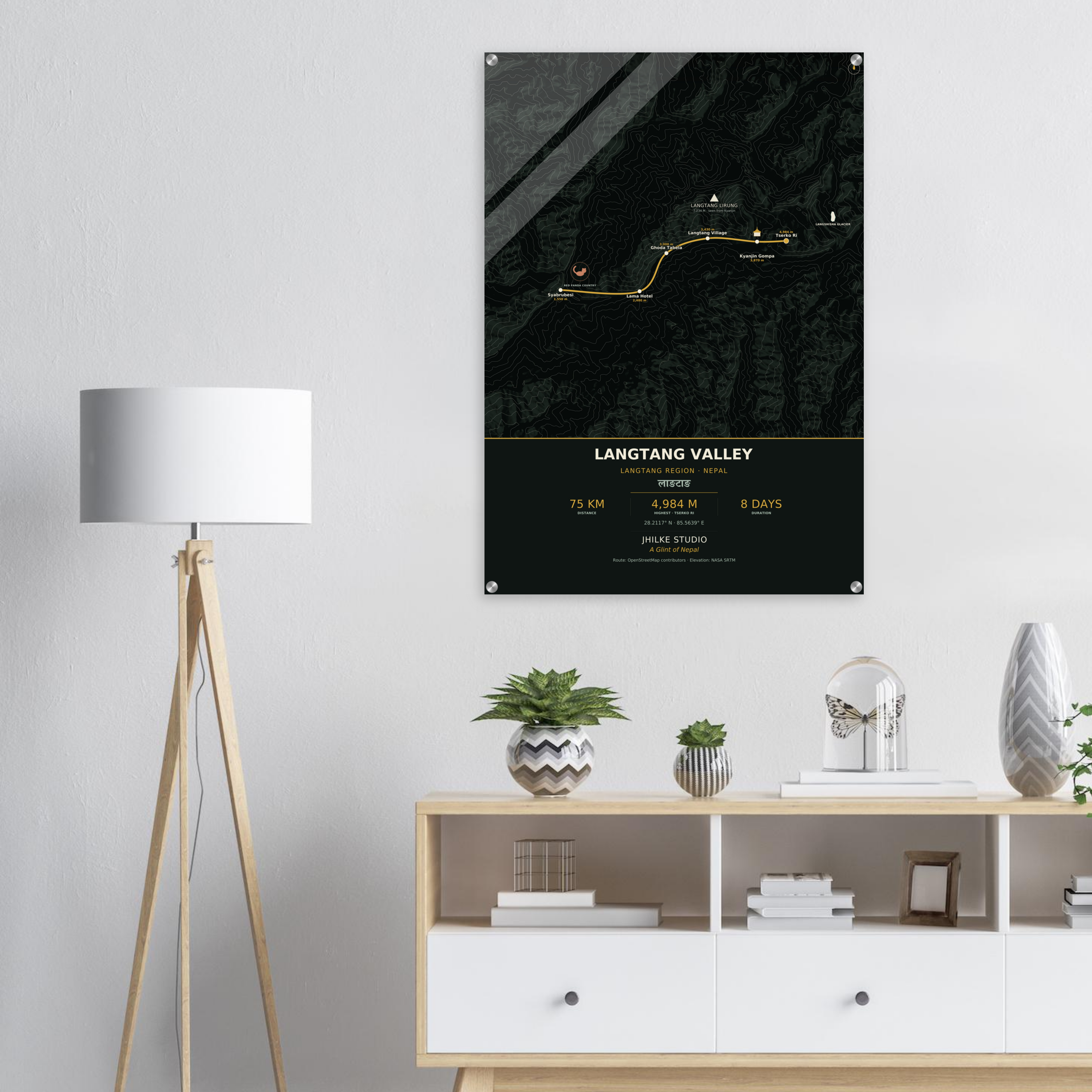 Langtang Valley trek route map in the dark colourway, shown as an acrylic glass print mounted on a wall. Jhilke Studio.