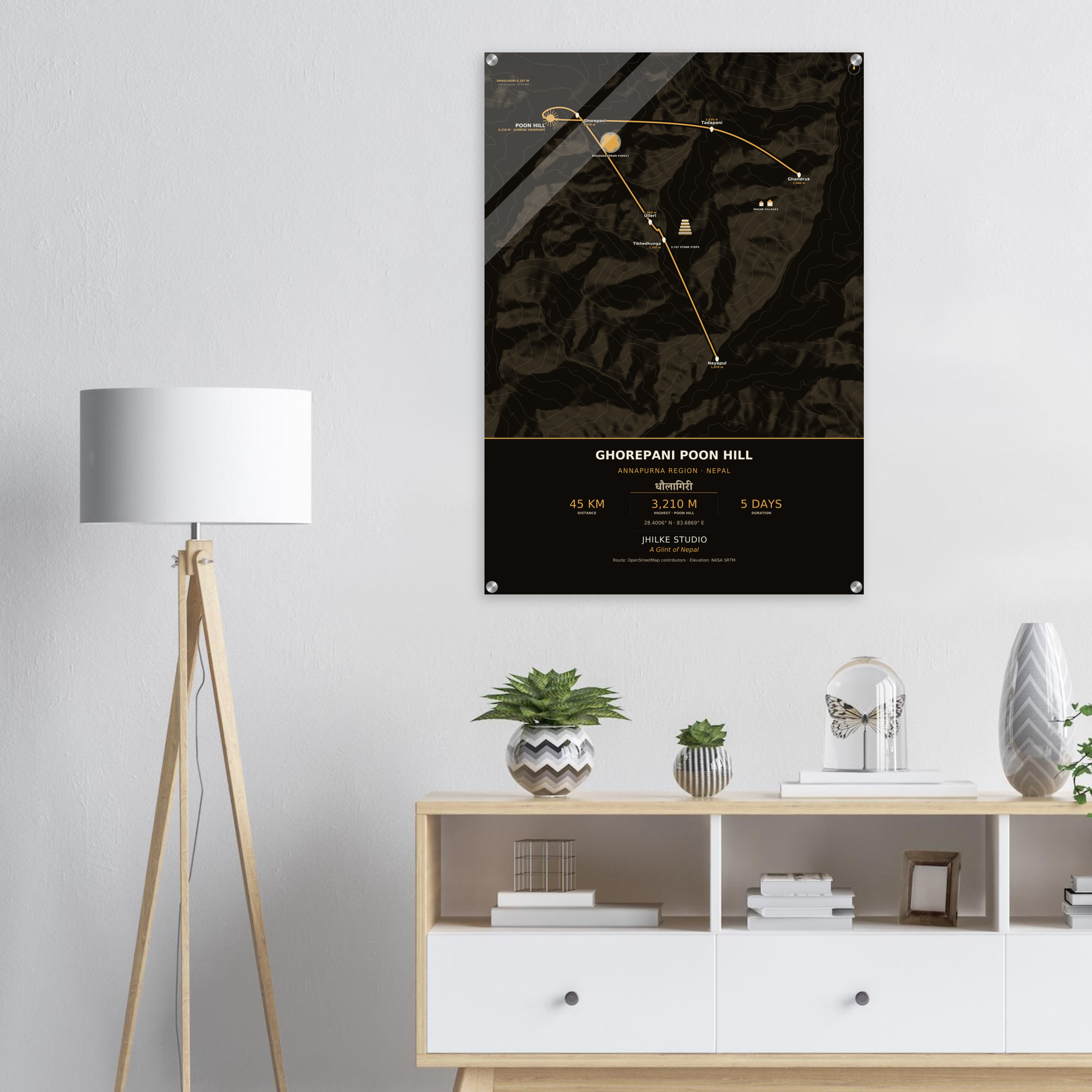 Ghorepani Poon Hill trek route map in the dark colourway, shown as an acrylic glass print mounted on a wall. Jhilke Studio.