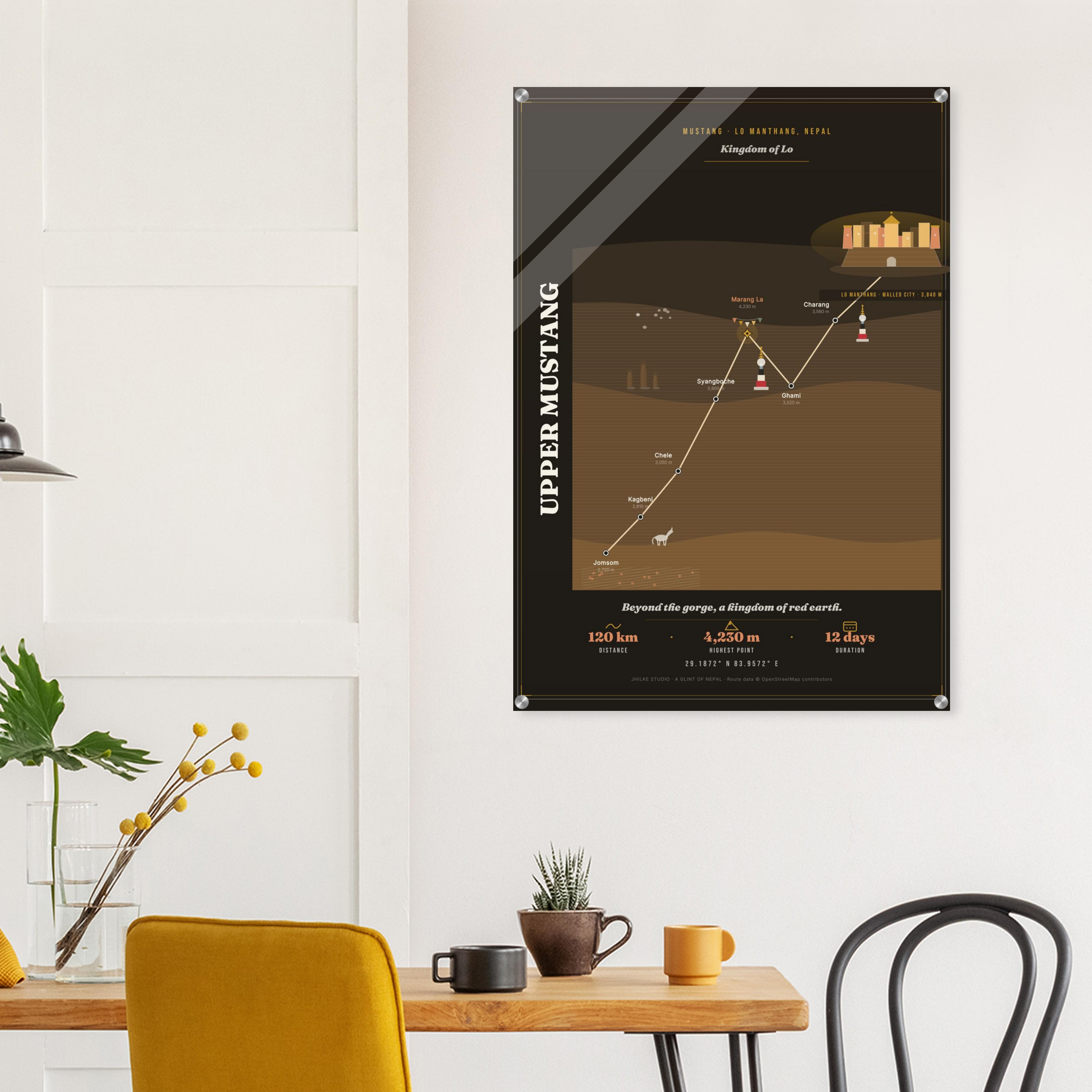 Upper Mustang trek route map in the dark colourway, shown as an acrylic glass print mounted on a wall. Jhilke Studio.