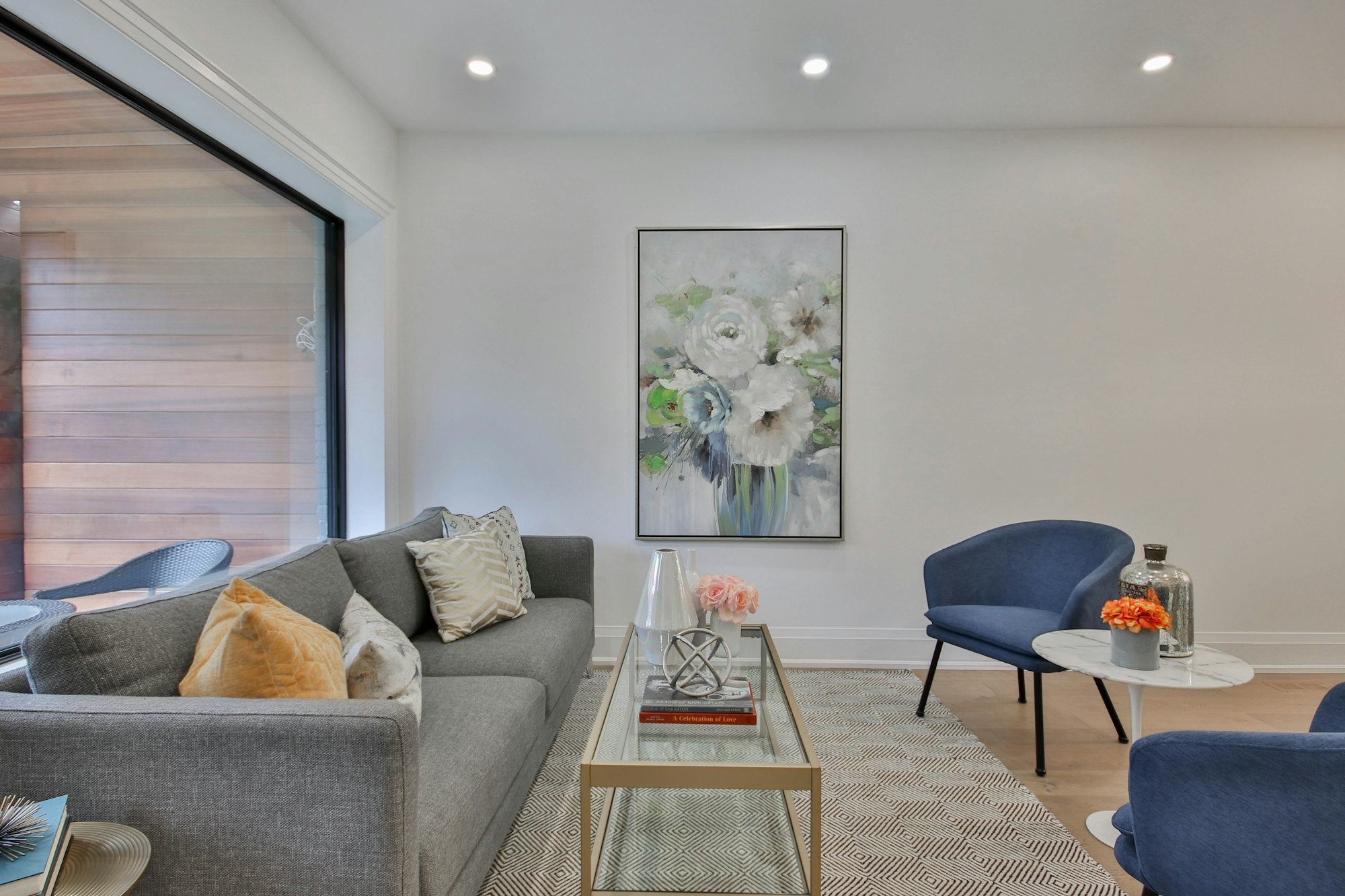 A styled living room with framed art on the wall